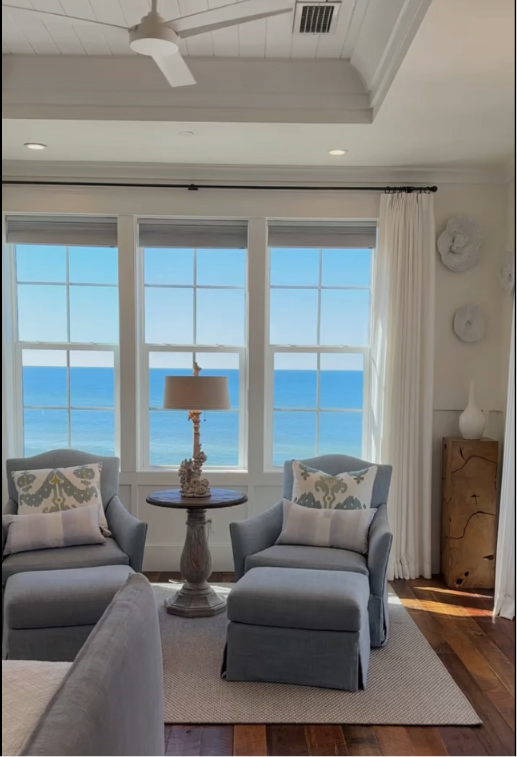 Airy coastal beachfront bedroom with seating area