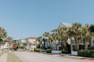 a row of houses near green trees under blue sky