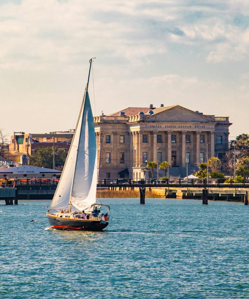 Sailboat in the water with the United States Custom house in the background in Charleston South Carolina