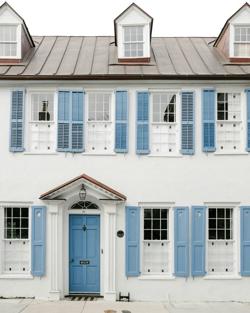historical old white house with blue shutters in Charleston South Carolina